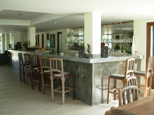 a bar with wooden bar stools in a restaurant at residence papillon in Thong Son Beach