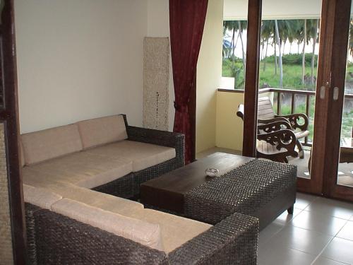 a living room with a couch and a table at residence papillon in Thong Son Beach