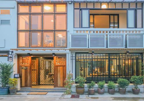 a building with plants in front of it at liaw base house in Bangkok
