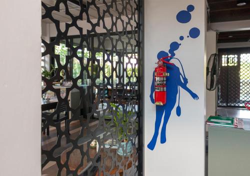 a wall with a painting of a woman on it at liaw base house in Bangkok