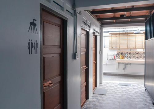 a hallway with two doors and a bathroom at liaw base house in Bangkok