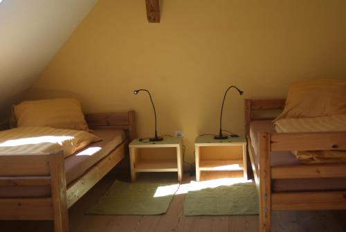 a bedroom with two beds and two lamps on tables at Ferienwohnung Haiberg in Rudolfing