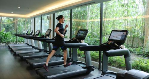 a woman running on a treadmill in a gym at Shangri-La Kuala Lumpur in Kuala Lumpur