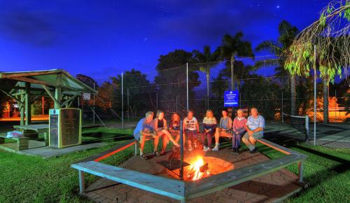 people sitting around a fire pit at Mountain View Resort in Shoalhaven Heads