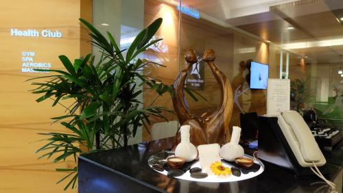 a office with a desk with a phone and a statue at Shangri-La Kuala Lumpur in Kuala Lumpur