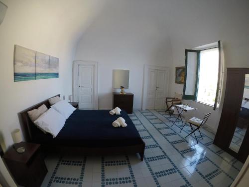 a bedroom with a bed with two teddy bears on it at Villa La Mura in Atrani