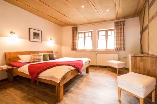 a bedroom with a large bed in a room at Schmidtburger Hof in Weiler