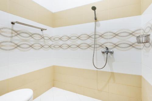 a bathroom with a shower with a toilet at RedDoorz Syariah @ Ketintang Surabaya in Surabaya
