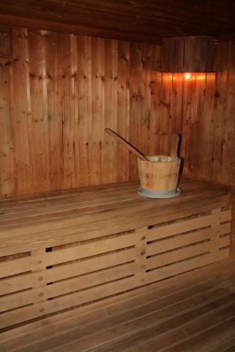a wooden sauna with a bucket on a wooden shelf at Club Hotel Casapueblo in Punta del Este