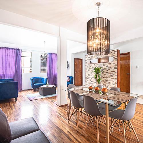 a dining room and living room with a table and chairs at Roma Sur Apartments with Balcony - Family Friendly in Mexico City