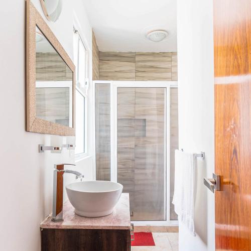 a bathroom with a bowl sink on a wooden table at Roma Sur Apartments with Balcony - Family Friendly in Mexico City