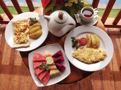 a table with plates of food and a teapot at D'jineng Rice Terrace Canggu in Canggu