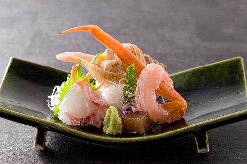 a plate of food with shrimp and vegetables on it at Nishimuraya Honkan in Toyooka