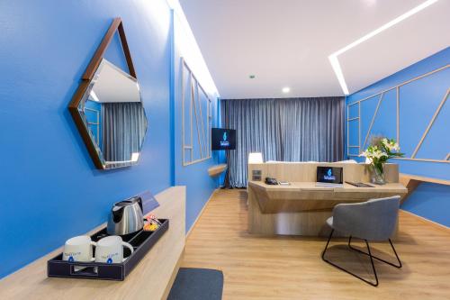an office with blue walls and a desk and a chair at BlueSotel SMART Krabi Aonang Beach - Adults only in Ao Nang Beach