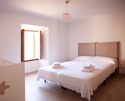 a bedroom with a bed with two towels on it at Can Calet in Marratxí 