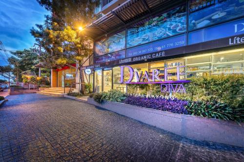 a store front at night with flowers in front of it at PLAAI Prime Hotel Rayong SHA Extra Plus in Rayong