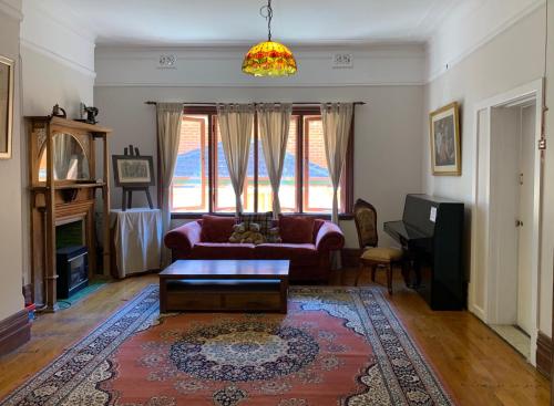 a living room with a couch and a table at Burwood Bed and Breakfast in Sydney
