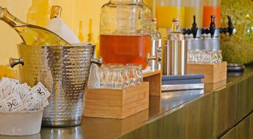 a counter with a bar with bottles and glasses at Hotel Caravel in Limone sul Garda