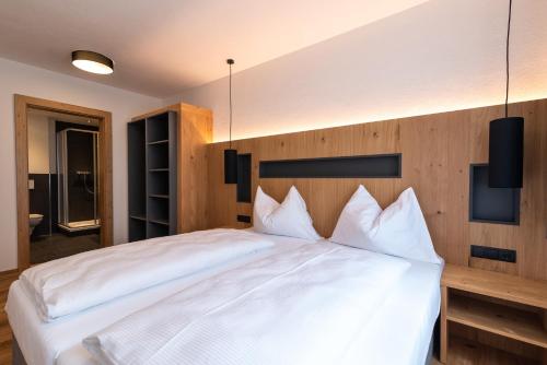 a bedroom with a large bed with white pillows at A Casa Elegance in Längenfeld