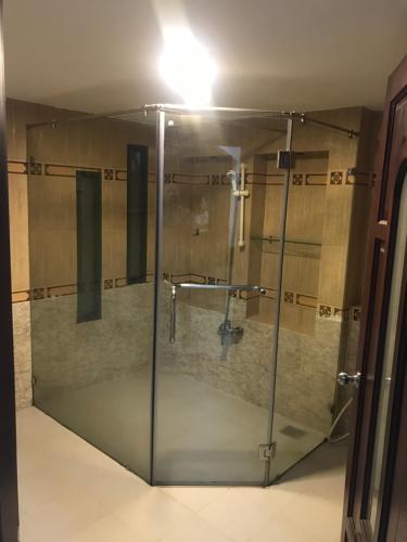 a glass shower in a bathroom with a sink at Nhật Vân 1 in Ho Chi Minh City