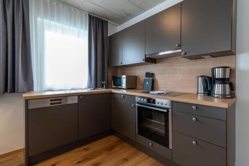 a kitchen with stainless steel appliances and a window at A Casa Elegance in Längenfeld