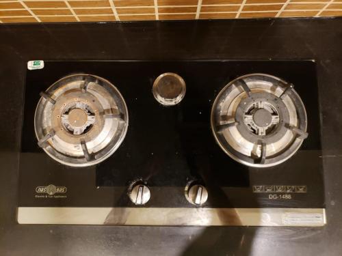 two burners on top of a black stove at Rove Lodging-One Bed Apartment,Bahria Town in Rawalpindi