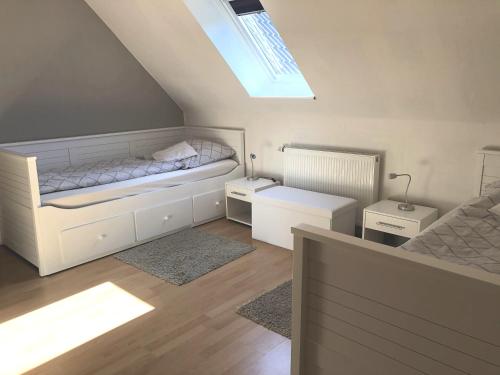 a attic bedroom with a bed and a skylight at Ferienwohnung Wansiedler in Sankt Peter-Ording
