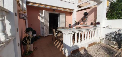a balcony of a house with a table and chairs at Casa Valerie GM003 in Guardamar del Segura
