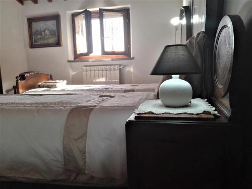 a bedroom with a bed and a lamp on a dresser at Casa Giulia in Prato