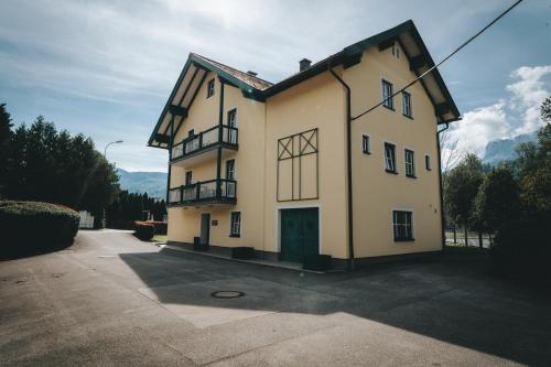 a large white building with two balconies on it at Brückenwirt in Hallein