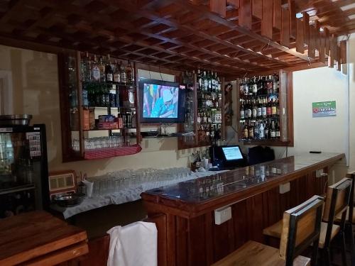 a bar in a restaurant with a television on the wall at Sahara Gardens-Kericho in Kericho