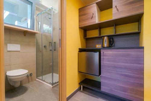 a bathroom with a toilet and a shower at Casa Livio - Rooms and studios in Como