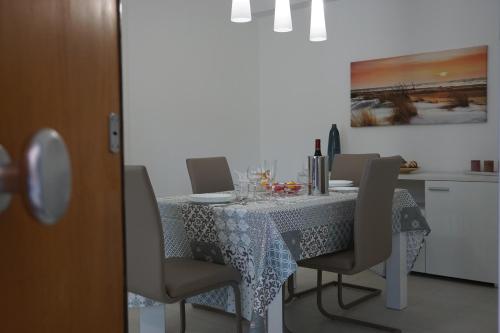 a dining room table with chairs and a table cloth at Casa Gisé in Aci Castello