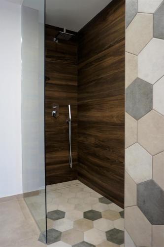 a shower with a glass door in a bathroom at Casa Gisé in Aci Castello