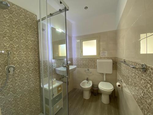 a bathroom with a toilet and a sink and a shower at Apartment Rua Formaggi in Palermo