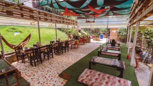 a restaurant with tables and chairs and a person standing in a room at Wander Thirst in Kathmandu