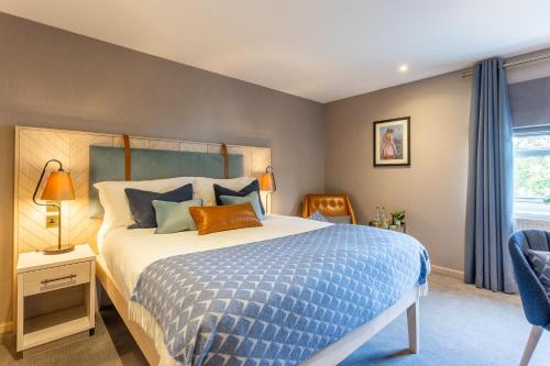 a bedroom with a bed with a blue comforter at Palm Court Hotel in Aberdeen