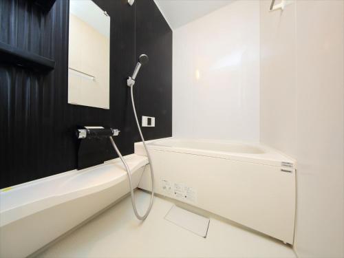 a bathroom with a shower and a white tub at COTO Tokyo Asakusa 4 in Tokyo