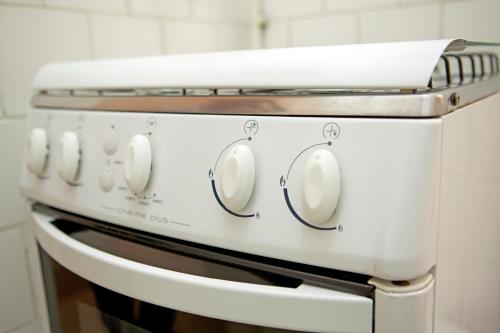 a white stove top oven in a kitchen at Apartamento Botafogo Beach in Rio de Janeiro