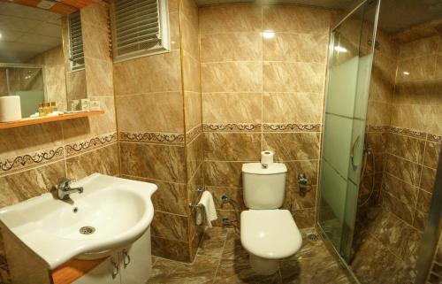 a bathroom with a sink and a toilet and a shower at Hotel Cenka Ephesus in Selcuk