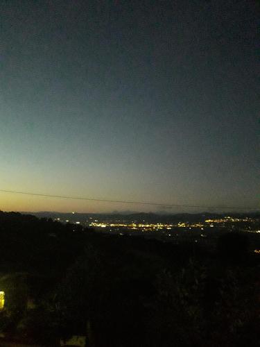 a view of a city at night with lights at Poggio La Grognola in Cannara