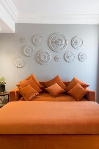 a bedroom with a large bed with orange pillows at Elizabeth Lifestyle Hotel in Bologna