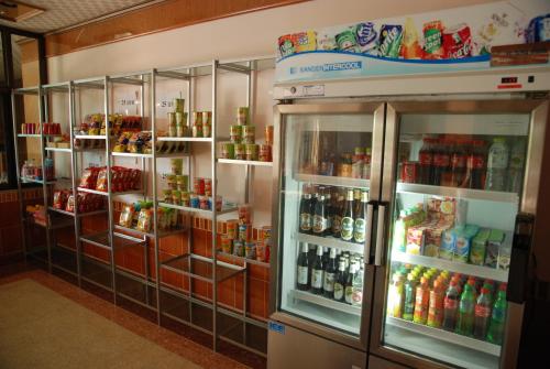 a refrigerator filled with lots of food and drinks at Rose Garden Hotel in Phra Nakhon Si Ayutthaya