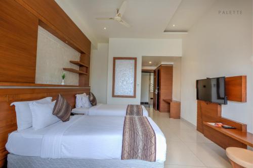Ένα ή περισσότερα κρεβάτια σε δωμάτιο στο Hotel Pioneer Grand Palace