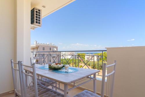 a table and chairs on a balcony with a view at Lovely Apartment Xylokastro 4th Floor in Xylokastron