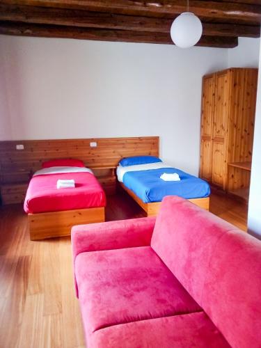 a living room with two beds and a couch at La casa del popolo in Prato Carnico