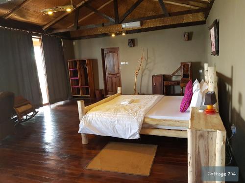 a bedroom with a large bed in a room at Wag Hill Lodge & Spa in Mwanza