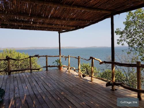 a wooden deck with a view of the ocean at Wag Hill Lodge & Spa in Mwanza