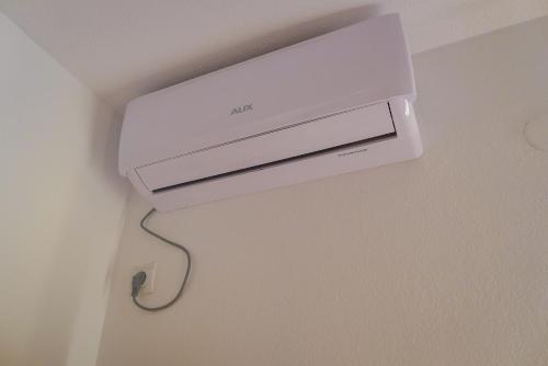 a white video game system hanging on a wall at Alise in Bar
