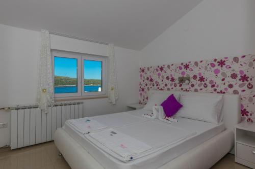 Postel nebo postele na pokoji v ubytování Villa Rossa Apartments